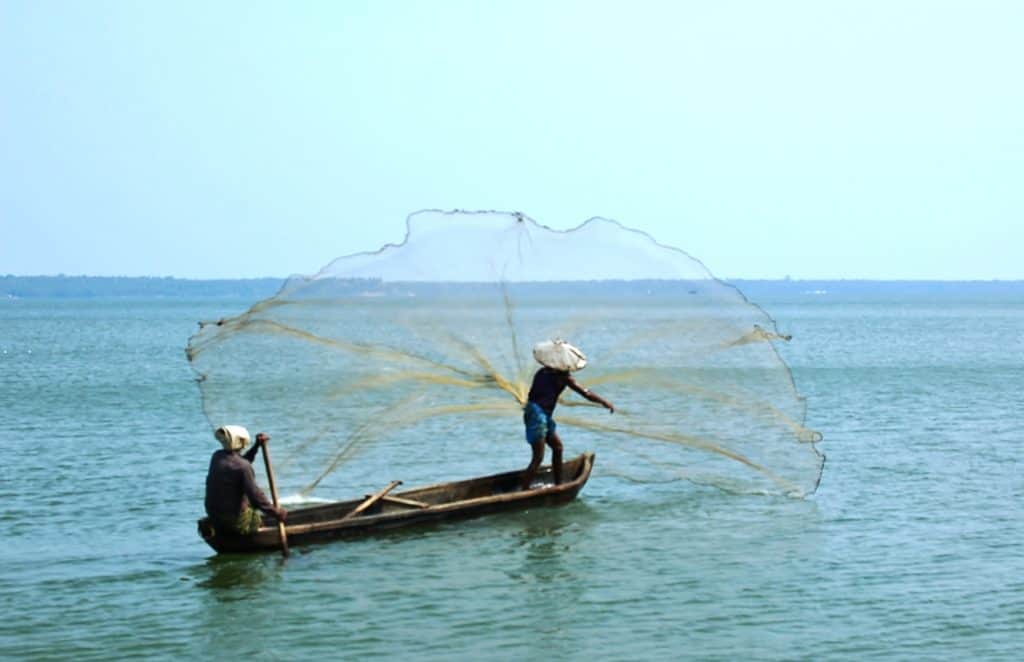 How to Plan for a vacation in India's backwaters - a canoe fishing boat with a fishing net