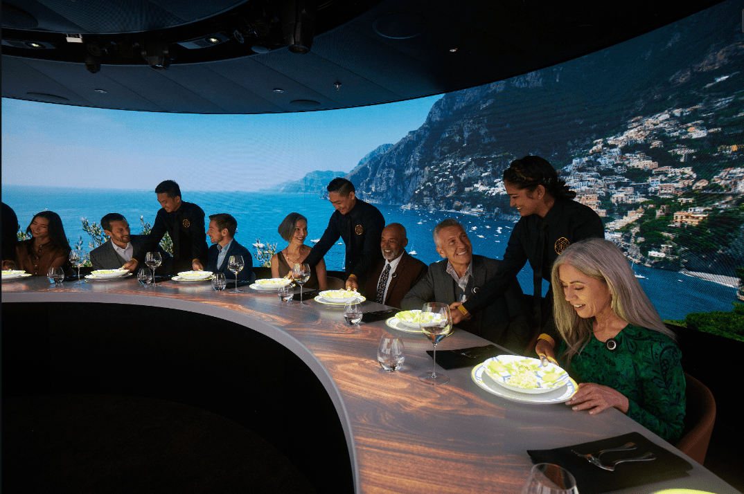 The Circular Table with Diners at the 360 Experience on the Discovery Princess