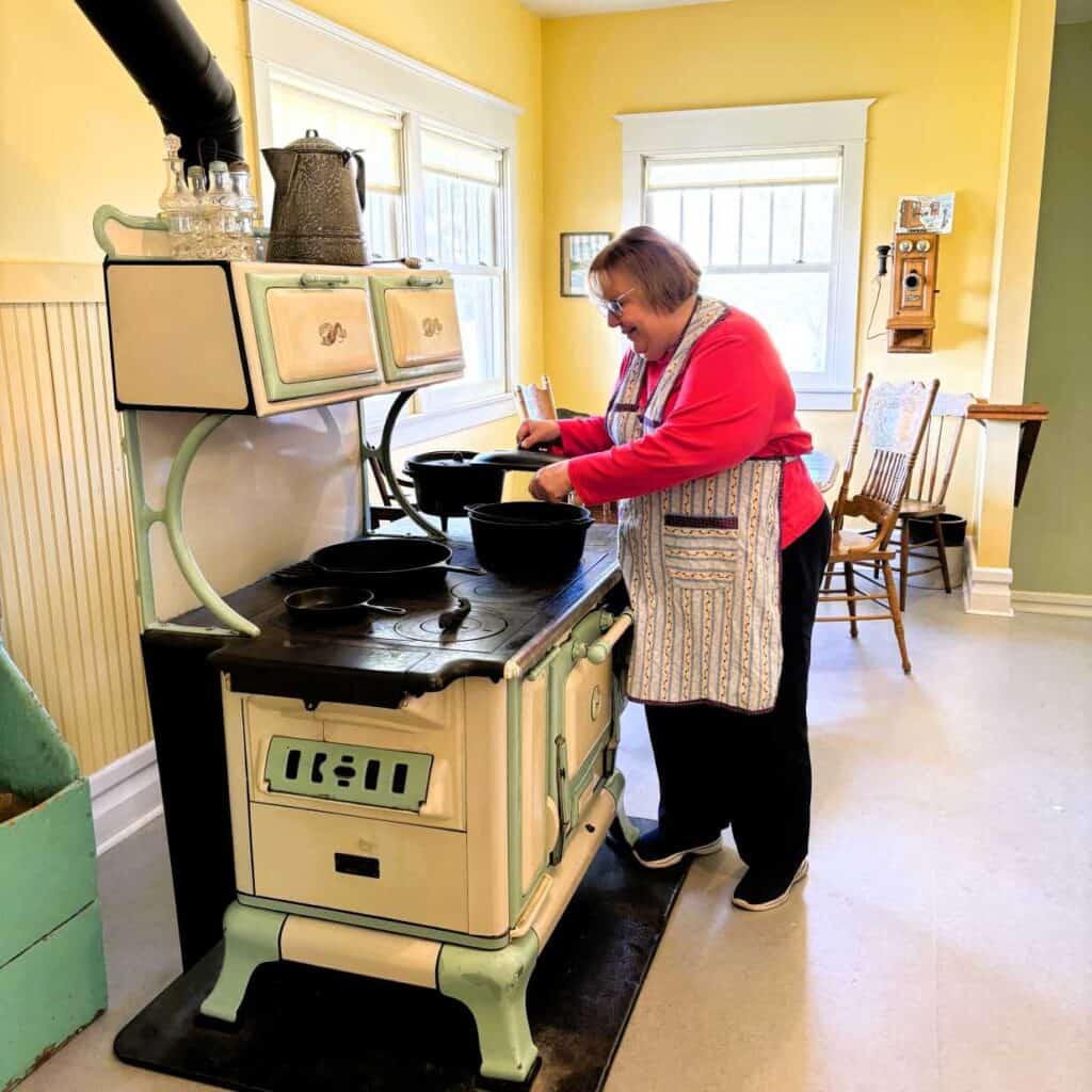 Cooking at the 1920s-era stove at the Farm in Prophetstown State Park