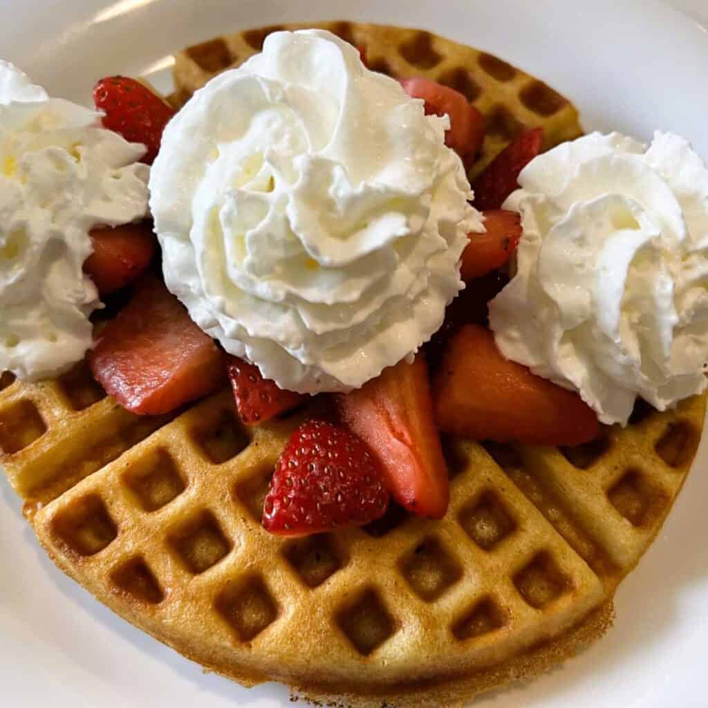 Waffle Topped with Strawberries and Whipped Cream at Christopher's Cafe one of the restaurants near Indian River, Michigan 