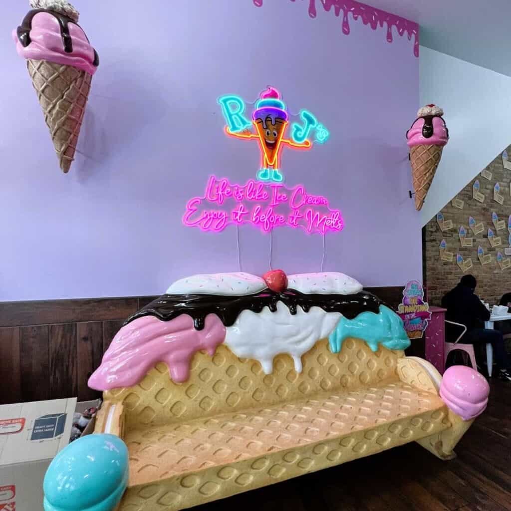 A hot pink neon sign reminds us, “Life is like ice cream; eat it before it melts.”