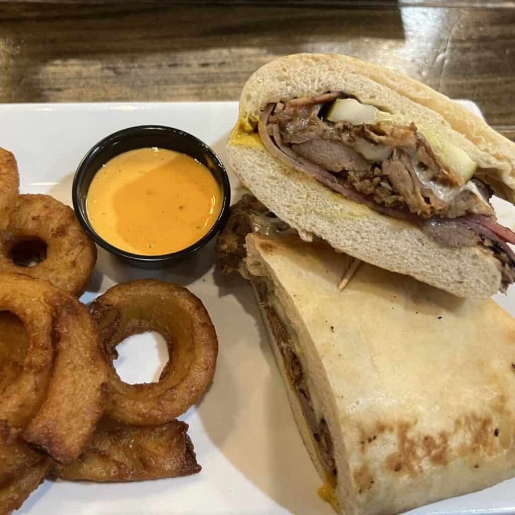 Cuban Hand Held with Onion Rings at Clam Lake Brewery one of the best places to eat in Cadillac, Michigan