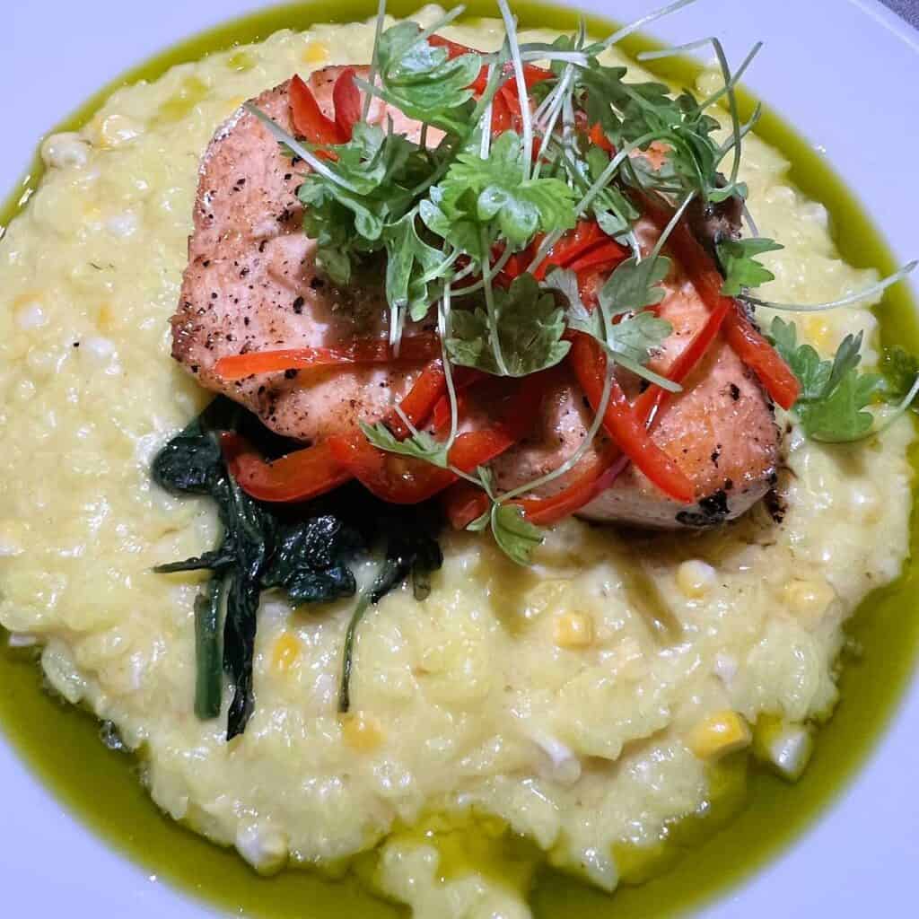 Roasted Salmon with Corn Risotto at one of the best places to eat in Lafayette Louisiana
