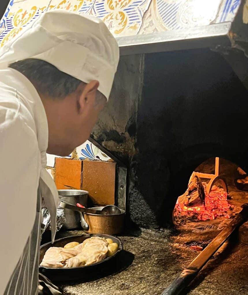The Cook Arranging the Roast in the Oven